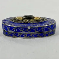 Early 20thC Oval Silver and Gold Enameled Pill Box with Tanzanite Gem